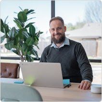 man sitting at desk with laptop