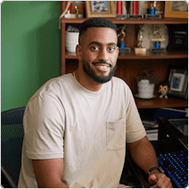 man in front of book shelf